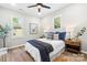 Bright bedroom featuring a ceiling fan, two bedside tables, and natural light at 403 Broad St, Kannapolis, NC 28081