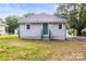 Exterior view of the house, with the green door facing the yard at 403 Broad St, Kannapolis, NC 28081