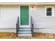 The home features a bright green front door, gray steps, and gray siding at 403 Broad St, Kannapolis, NC 28081