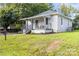 Exterior elevation showing the cozy bungalow with a covered porch and manicured lawn at 403 Broad St, Kannapolis, NC 28081