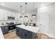 A sleek kitchen with stainless appliances, a center island, and a dining table setup at 403 Broad St, Kannapolis, NC 28081