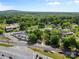Aerial photo of a property with a gray house near train tracks and a car lot at 4304 S Falls St, Gastonia, NC 28056