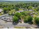 Aerial view of a property featuring a gray house near train tracks and a car lot at 4304 S Falls St, Gastonia, NC 28056