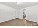 Spacious bedroom with hardwood floors and a view into the cozy living area at 4304 S Falls St, Gastonia, NC 28056