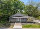 Inviting single-story home featuring a cozy front porch and well-maintained landscaping at 4304 S Falls St, Gastonia, NC 28056