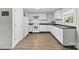 Modern kitchen with white cabinetry, stainless steel appliances, and a subway tile backsplash at 4304 S Falls St, Gastonia, NC 28056