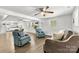 Open-concept living area with hardwood floors, ceiling fans, and plenty of natural light at 4304 S Falls St, Gastonia, NC 28056