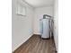 The utility room has neutral walls and wood-look flooring at 4304 S Falls St, Gastonia, NC 28056