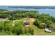 Aerial view showcases a house nestled among lush trees, expansive land, and a serene body of water at 4377 Kiser Island Rd, Terrell, NC 28682