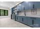 Basement area featuring blue cabinets, sleek countertops, black hardware, and modern lighting at 4377 Kiser Island Rd, Terrell, NC 28682