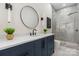 Bathroom features a modern vanity with marble countertop and a frameless glass shower at 4377 Kiser Island Rd, Terrell, NC 28682