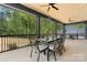 Inviting covered patio with ceiling fans features an outdoor dining area and a comfortable lounge area at 4377 Kiser Island Rd, Terrell, NC 28682
