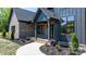 Inviting front entrance with a walkway, a covered porch, and beautiful landscaping at 4377 Kiser Island Rd, Terrell, NC 28682