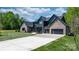 Gorgeous modern home with mixed brick and board siding, a long driveway, and a spacious three-car garage at 4377 Kiser Island Rd, Terrell, NC 28682