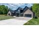 Beautiful modern home with brick and board siding, a concrete driveway, and manicured lawn at 4377 Kiser Island Rd, Terrell, NC 28682