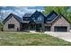 Beautiful home featuring a combination of modern black wood and brick, complemented by a well-manicured lawn at 4377 Kiser Island Rd, Terrell, NC 28682