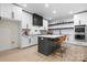 Modern kitchen with white cabinets, dark countertops, and a center island with seating at 4377 Kiser Island Rd, Terrell, NC 28682