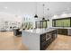 Open kitchen with an island, pendant lighting, dining area, and large windows offering natural light at 4377 Kiser Island Rd, Terrell, NC 28682