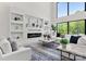 Open-concept living room with a large built-in wall unit, fireplace, and plenty of natural light at 4377 Kiser Island Rd, Terrell, NC 28682
