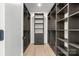 Spacious walk-in closet featuring custom dark wood shelving and drawers offering plenty of storage space at 4377 Kiser Island Rd, Terrell, NC 28682