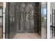 Modern wine cellar displays wine bottles against a marble wall, and has a glass door at 4377 Kiser Island Rd, Terrell, NC 28682