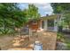 Enjoy the home's backyard patio featuring a dining table set, lush trees, and outdoor seating at 4920 Raymond Pl, Charlotte, NC 28205