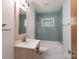 Modern bathroom featuring a new vanity, updated fixtures, and stylish blue subway tile at 4920 Raymond Pl, Charlotte, NC 28205