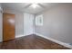 Bedroom showcasing hardwood floors, fresh paint, windows with blinds, and closet at 4920 Raymond Pl, Charlotte, NC 28205