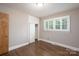 Comfortable bedroom featuring hardwood floors, large windows, and a built-in closet at 4920 Raymond Pl, Charlotte, NC 28205
