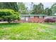 Classic brick home with a tidy front yard and mature landscaping at 4920 Raymond Pl, Charlotte, NC 28205
