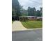 Charming brick home featuring a well-manicured lawn and mature trees at 4920 Raymond Pl, Charlotte, NC 28205
