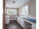 Spacious laundry room with ample natural light, a utility sink, and plenty of counter space at 4920 Raymond Pl, Charlotte, NC 28205