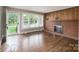 Bright living room boasts hardwood floors, fireplace and large windows at 4920 Raymond Pl, Charlotte, NC 28205