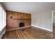 Spacious living room featuring hardwood floors and a classic brick fireplace at 4920 Raymond Pl, Charlotte, NC 28205