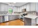 A bright, modern kitchen with gray cabinets, mosaic backsplash, and stainless steel appliances at 505 2Nd Street Ne Pl # C4, Conover, NC 28613