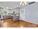 Open kitchen featuring stainless appliances, stylish backsplash, and hardwood flooring at 505 2Nd Street Ne Pl # C4, Conover, NC 28613