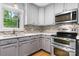 Charming kitchen with stainless steel oven and microwave, decorative tile backsplash and wood floors at 505 2Nd Street Ne Pl # C4, Conover, NC 28613