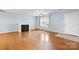 Inviting living room with hardwood floors, fireplace, ceiling fan and a front door at 505 2Nd Street Ne Pl # C4, Conover, NC 28613