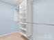 Bright walk-in closet offering adjustable shelving and a rod for optimal storage solutions at 505 2Nd Street Ne Pl # C4, Conover, NC 28613