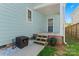 Back entrance to the home featuring a small porch, steps, and vibrant flowers at 507 E Main St, Rock Hill, SC 29730