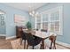 Charming dining room featuring a modern chandelier and a large window with natural light at 507 E Main St, Rock Hill, SC 29730