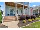 Inviting front porch with brick steps, seating, and charming curb appeal at 507 E Main St, Rock Hill, SC 29730