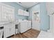 Well-equipped laundry room with washer, dryer, storage cabinets, sink and exterior access at 507 E Main St, Rock Hill, SC 29730