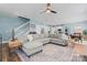 Spacious living room featuring a large sectional sofa, ceiling fan, and open layout to the kitchen at 507 E Main St, Rock Hill, SC 29730
