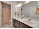 A bathroom featuring double sinks, a large mirror, and a shower with curtain at 525 Chase Prairie Ln, Waxhaw, NC 28173