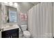 Bathroom featuring a shower with curtain, a large mirror, and a toilet at 525 Chase Prairie Ln, Waxhaw, NC 28173