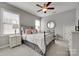 Well-lit bedroom boasts a ceiling fan, and a charming round mirror on the wall at 525 Chase Prairie Ln, Waxhaw, NC 28173