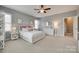 Bright bedroom featuring neutral walls, a ceiling fan, and a large window at 525 Chase Prairie Ln, Waxhaw, NC 28173