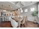 Bright dining area adjacent to kitchen, featuring hardwood floors and modern lighting at 525 Chase Prairie Ln, Waxhaw, NC 28173