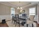Elegant dining room with tray ceiling, chandelier, wainscoting, and an arched window at 525 Chase Prairie Ln, Waxhaw, NC 28173
